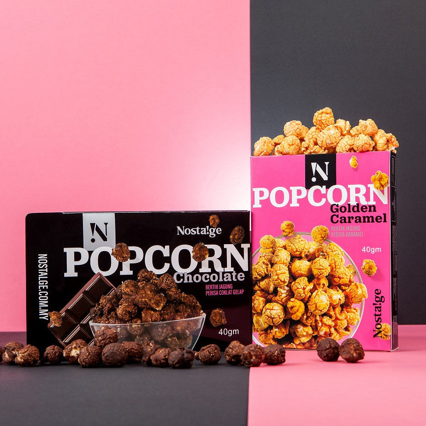 Nostalgia Popcorn and Popcorn Chocolate packages on a pink and black background