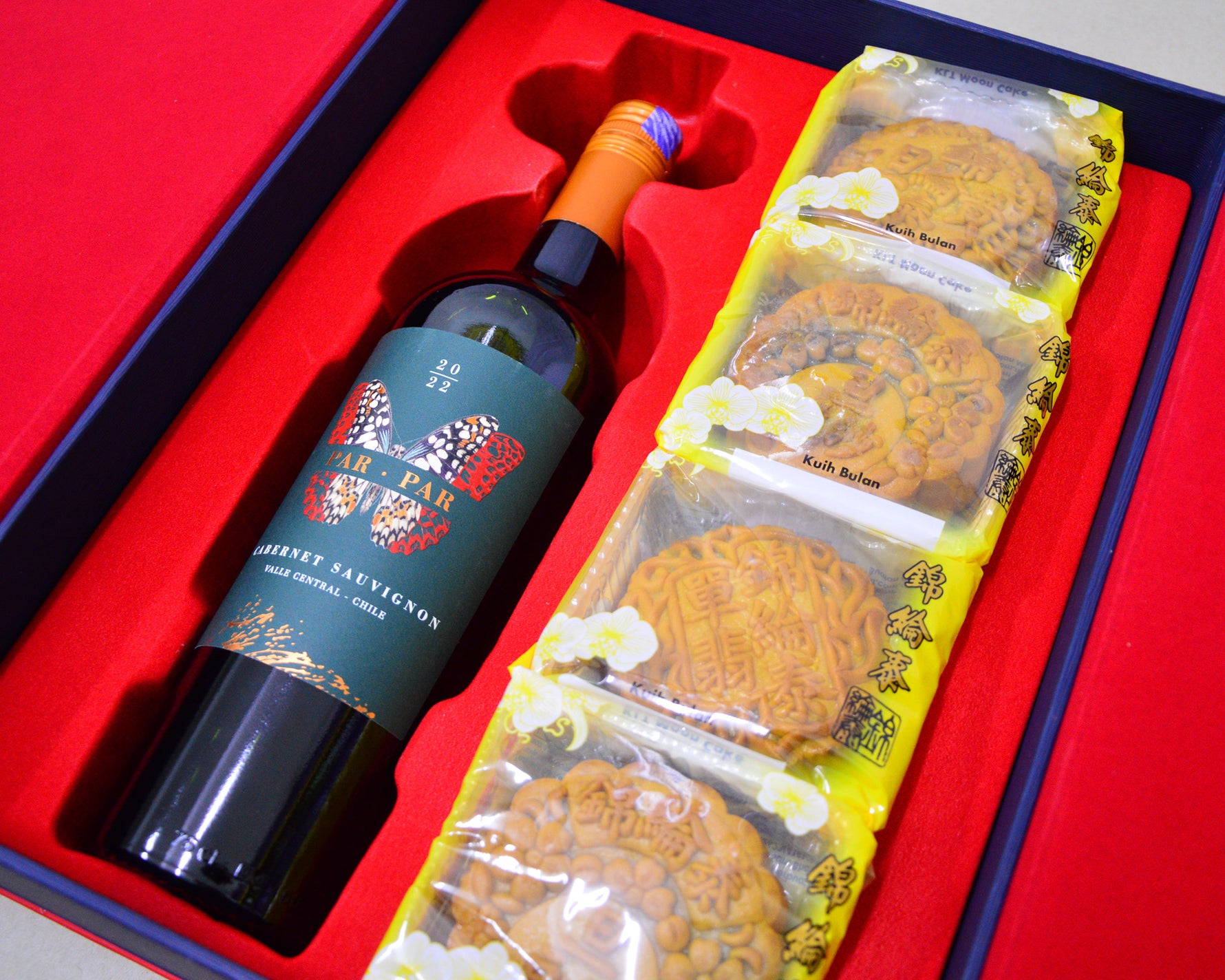Wine bottle and mooncakes in a red box