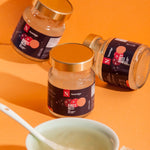 Three jars of Bird's Nest on an orange background with a bowl and spoon.