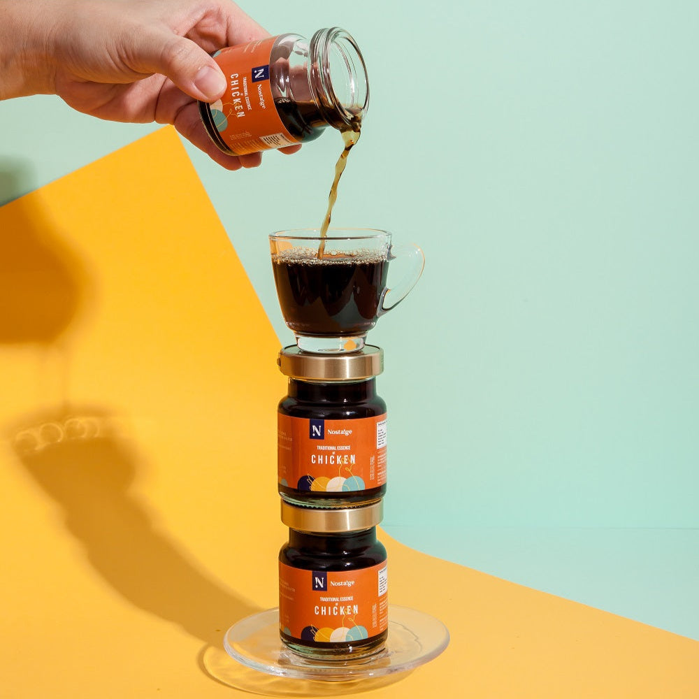 Person pouring coffee from a jar into a filter over a stack of Nespresso coffee pods on a colorful background