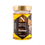 Jar of Nostalge wild honey with a gold lid on a white background