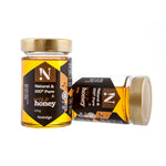 Two jars of honey with labels on a white background