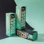Three boxes of Sesame Straws on a green and black background