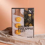 Packaging of Golden Pineapple Tart with a peach-colored background