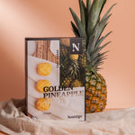 Nostalgia Golden Pineapple package with a pineapple on a beige background