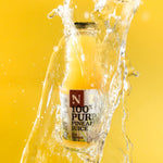 Bottle of 100% Pure Pineapple Juice with splashing liquid on a yellow background