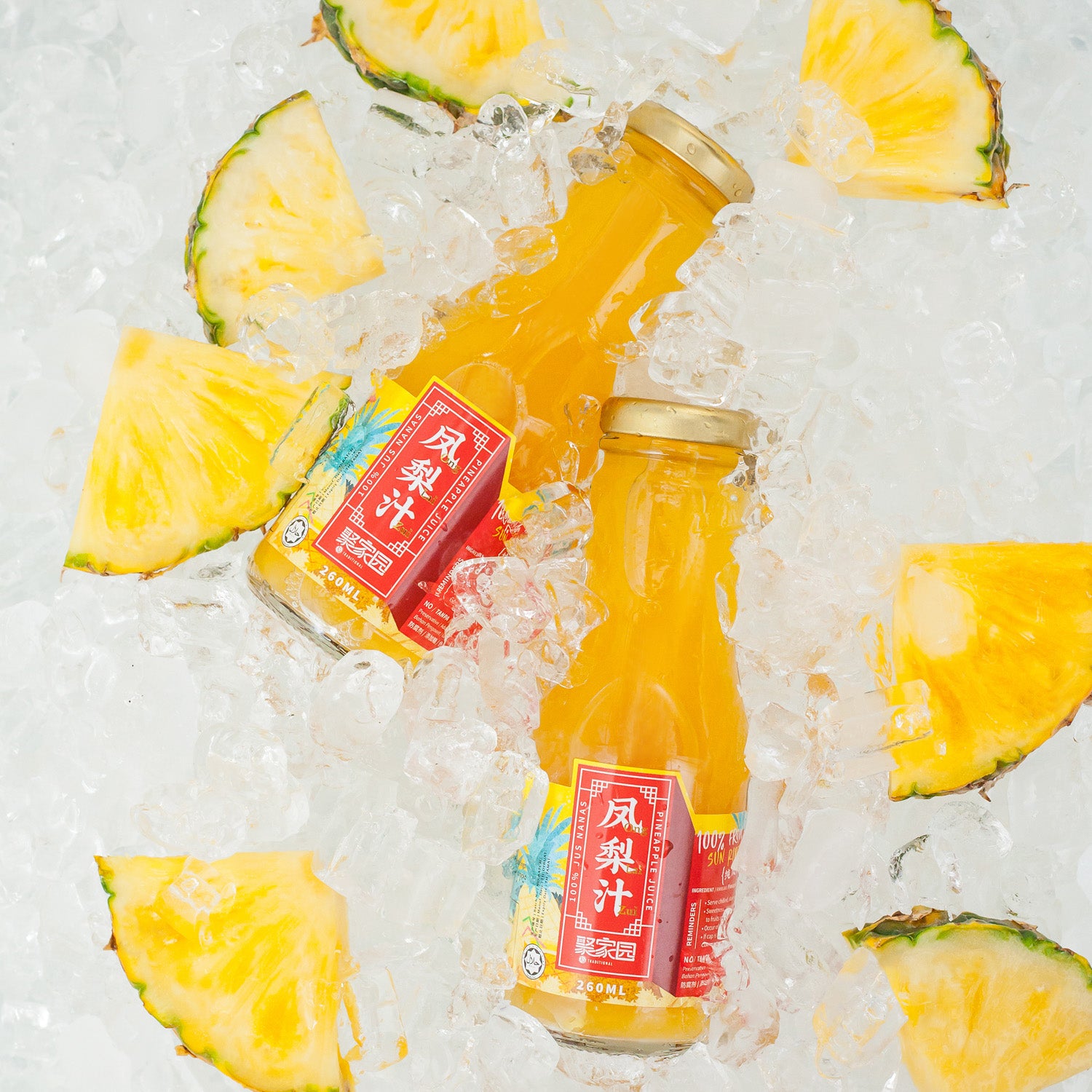 Two bottles of pineapple juice on ice with pineapple slices around