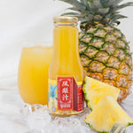 Pineapple juice bottle with a glass of juice and a pineapple on a white background