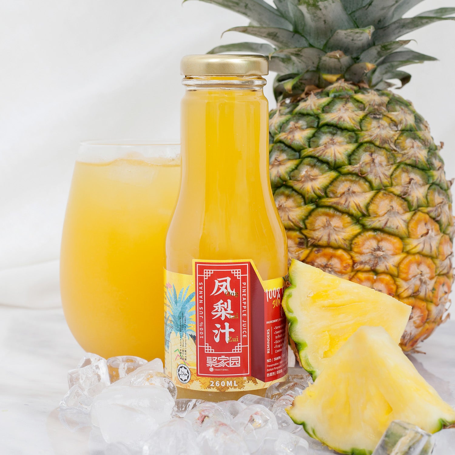 Pineapple juice bottle with a glass of juice and a pineapple on a white background