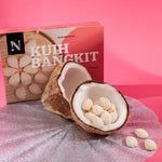 Kuih Bangkit cookies in a coconut shell with packaging on a pink background