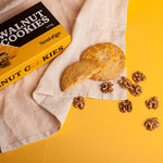 Walnut cookies with a box labeled 'Walnut Cookies' on a yellow background