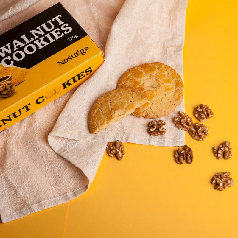 Walnut cookies with a box labeled 'Walnut Cookies' on a yellow background